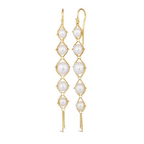 A pair of long 18k yellow gold earrings are crafted with graduated white pearls suspended in delicate chain. The earrings are fastened with French hook closures.