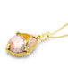 A teardrop shaped Mexican opal stone is set in an 18k yellow gold chain wrapped bezel with four beaded prongs. The pendant hangs on a delicate chain.