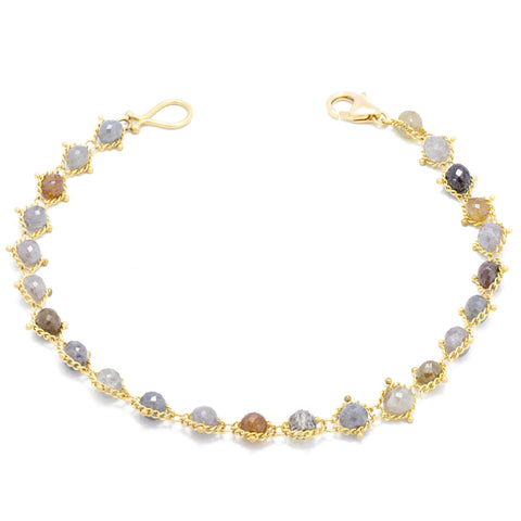 This 18k yellow gold bracelet features multi-colored diamond beads woven throughout a delicate chain. The bracelet features a lobster clasp closure.