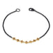 This oxidized sterling silver bracelet features a row of champagne diamonds suspended in 18k yellow gold chain in the center.