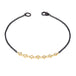 This oxidized sterling silver bracelet features a row of silver diamonds suspended in 18k yellow gold chain in the center.