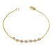 This delicate 18k yellow gold chain bracelet features a row of woven tanzanites in the center and closes with a lobster clasp.