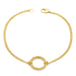This delicate 18k yellow gold chain bracelet features a circle in the center with a stardust like effect.