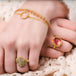 This delicate 18k yellow gold chain bracelet features a circle in the center with a stardust like effect.
