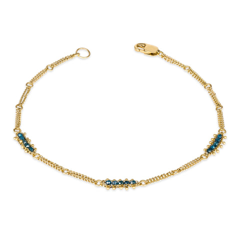 This 18k yellow gold chain bracelet features three blue diamond bars stationed throughout. The bracelet is finished with a lobster clasp.