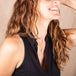 A model wears a small turquoise pendant that is set in 18k yellow gold on a short chain.