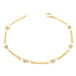 This delicate 18k yellow gold chain bracelet is dotted with silver diamond beads throughout. The bracelet is finished with a lobster clasp closure.