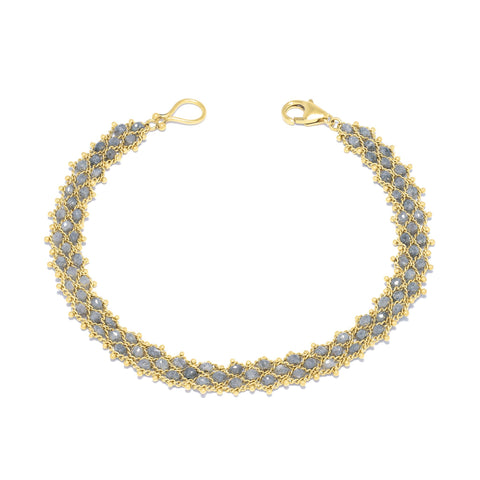 This delicate 18k yellow gold chain bracelet features three rows of woven silver diamonds. The bracelet is finished with a lobster clasp closure.