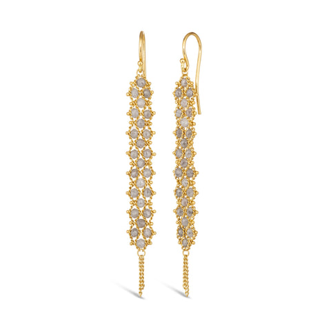 A pair of long grey diamond earrings features a woven lattice pattern and two dangling chains at the bottom of the earring. The earrings fasten with french hook closures.