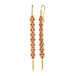 A pair of long red spinel earrings features a woven lattice pattern and two dangling chains at the bottom of the earring. The earrings fasten with french hook closures.