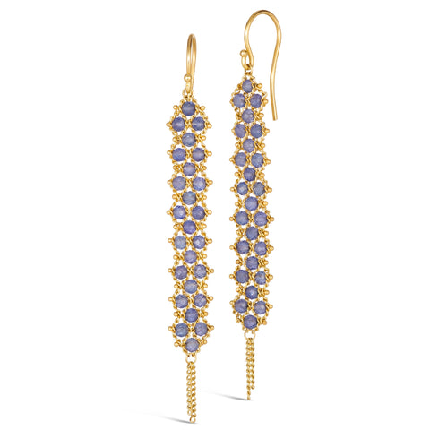 A pair of long tanzanite earrings features a woven lattice pattern and two dangling chains at the bottom of the earring. The earrings fasten with french hook closures.