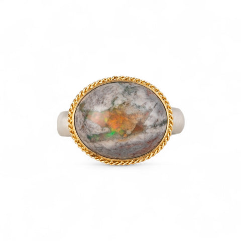 Handmade ring with a mexican opal stone, gold setting and sterling silver band