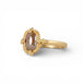 Gold ring with a brown diamond on a white background
