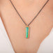 Handcrafted necklace featuring an Australian opal doublet stone set in a gold bezel and paired with an oxidized silver chain, worn on a person's neck.