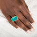 Gold and silver ring with gem silica gemstone on a person's finger