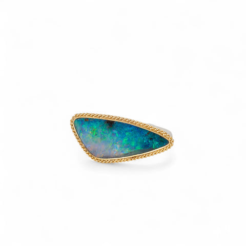 Handmade fine jewelry boulder opal ring with an 18k gold bezel and sterling silver band