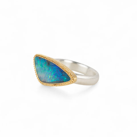 Handmade fine jewelry boulder opal ring with an 18k gold bezel and sterling silver band