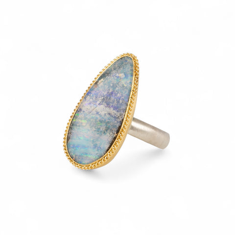 Handmade fine jewelry boulder opal ring with an 18k gold bezel and sterling silver band