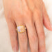 Handmade ring featuring a boulder opal gemstone set in an 18k gold bezel and paired with a sterling silver band, worn on a person's finger.