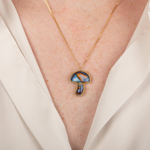 Boulder Opal mushroom necklace in gold on a person