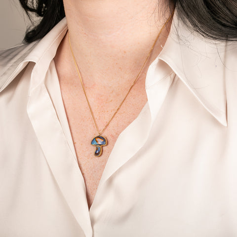 Boulder Opal mushroom necklace in gold on a person