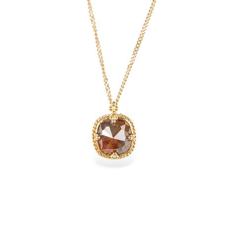 Necklace with a natural brown diamond set in a handmade gold bezel on a white background