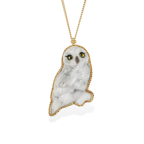 Handmade gold necklace featuring a hand carved owl quartz pendant on a white background.