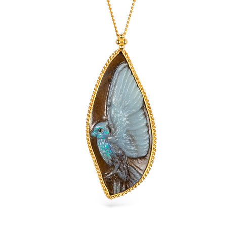 Carved phoenix boulder opal necklace in a gold setting