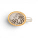 Gold and silver ring with a dendritic quartz stone on a white background