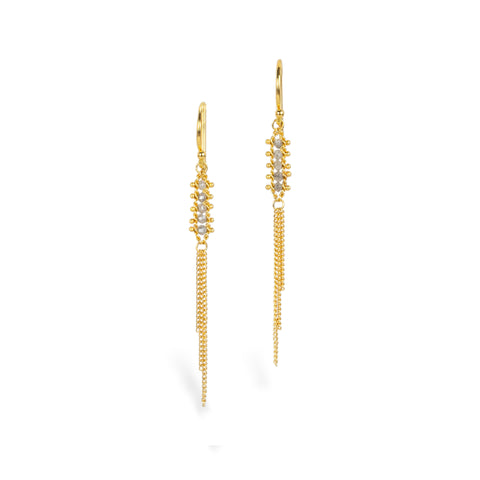 Gold earrings with gold tassels dangling between rows of four silver diamonds, against a white background.