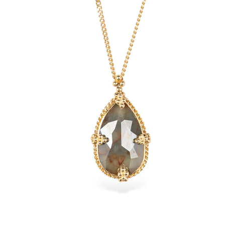 Necklace with a teardrop-shaped diamond set in a handcrafted gold bezel on a white background
