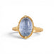 Gold ring with a blue dumortierite stone on a white background