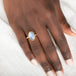 Gold ring with a blue dumortierite stone on person's finger