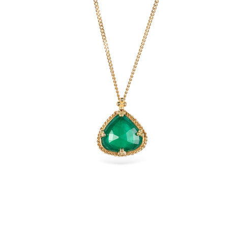 Handmade necklace with a one-of-a-kind emerald gemstone set in a handmade gold bezel on a white background. 