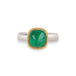 A ring featuring a cushion-cut emerald gemstone in a gold bezel setting, paired with a silver band, shown against a plain white background.