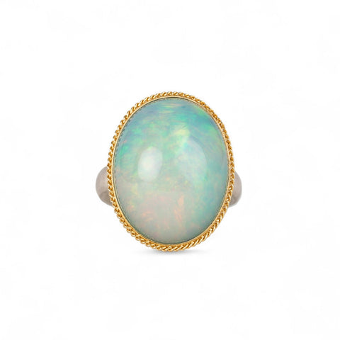 Ethiopian opal ring with a gold bezel and sterling silver band