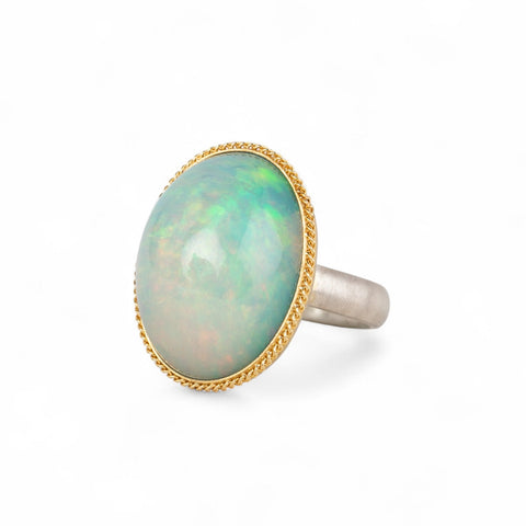 Ethiopian opal ring with a gold bezel and sterling silver band