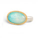 An oval ring featuring a light blue-green opal stone in a gold setting, with a silver-toned band, shown on a plain white background.