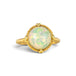 Gold ring featuring a circular Ethiopian opal gemstone set in a handmade 18k gold bezel, against a white background.