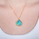 Ethiopian opal pendant necklace with gold setting on a person
