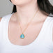 Ethiopian opal pendant necklace with gold setting on a person