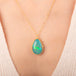 Handcrafted gold necklace featuring a large, teardrop-shaped Ethiopian opal gemstone set in an 18k gold bezel with a matching gold chain, shown worn on a person's neck.