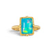 A handmade gold ring featuring an Ethiopian opal gemstone, against a white backdrop.