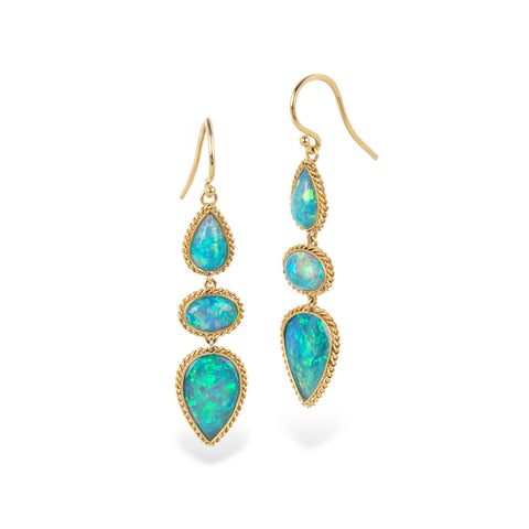 Gold earrings with australian opal stones on a white background