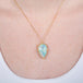 Ethiopian opal pendant necklace with 18k gold bezel on a person