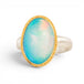 Ring with a gold bezel and silver band and a large Ethiopian opal gemstone on a white background