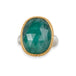 An oval emerald gemstone ring with a textured gold bezel and a sterling silver band, shown on a plain white background.
