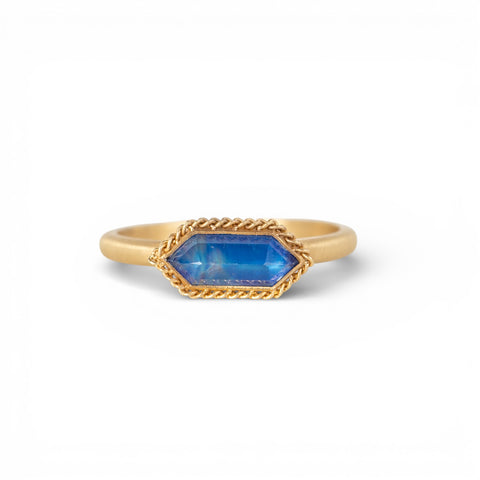 Gold ring with a moonstone on a white background