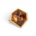 Hexagonal tourmaline gemstone ring with gold band on a white background