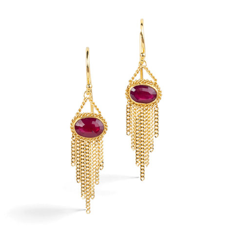 Gold earrings featuring oval rhodolite garnet gemstones, shown against a white background.
